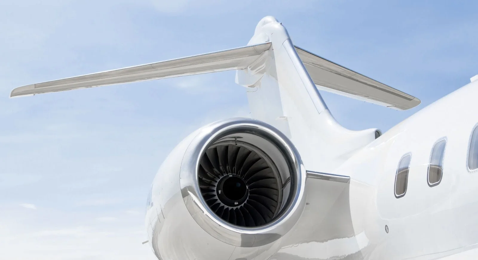 Close-up view of private jet engine turbine blades and wing showcasing aircraft engineering excellence
