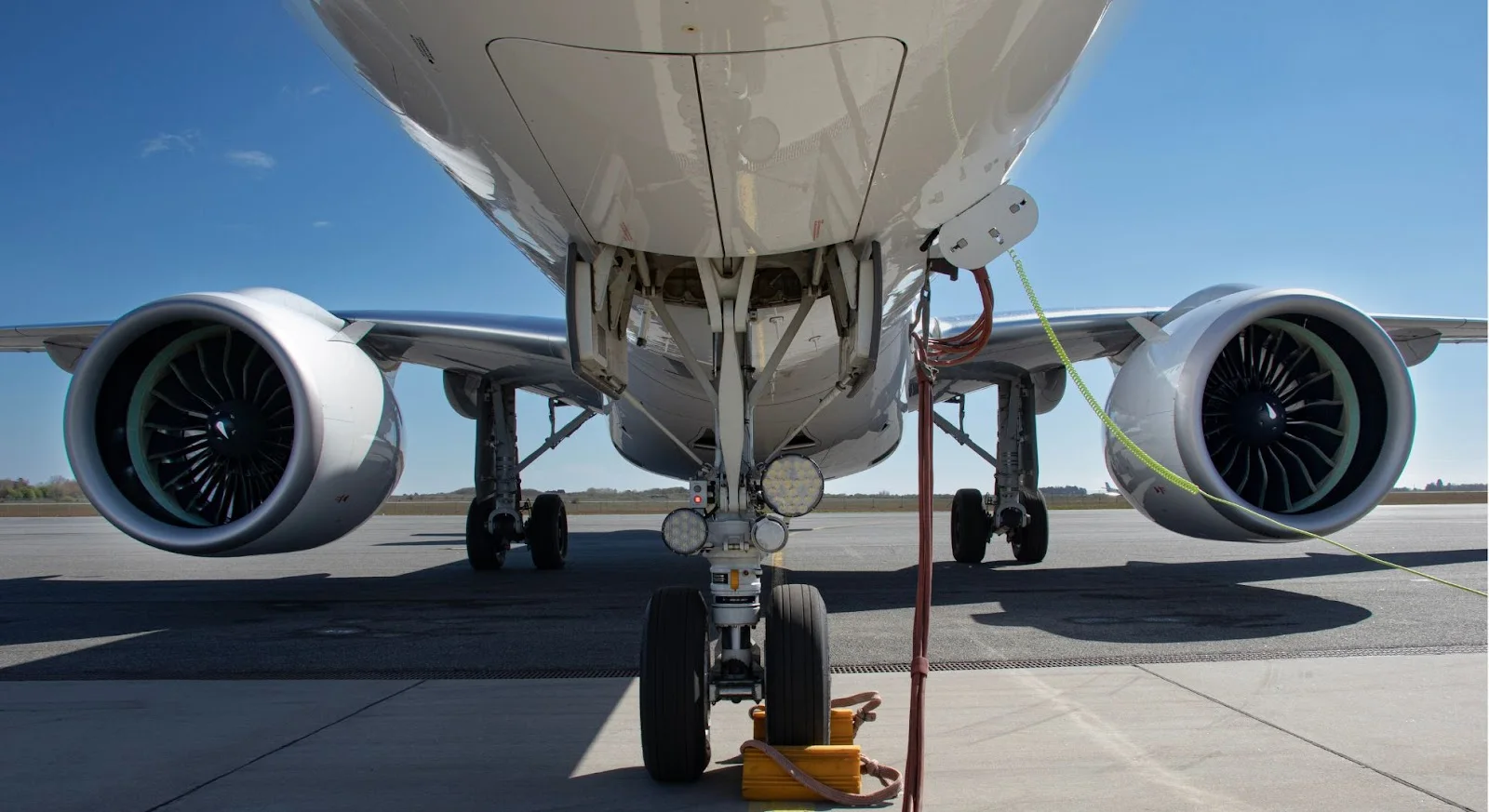 Private jet landing gear and twin engines on tarmac showcasing aircraft maintenance for Seoul-Tokyo routes