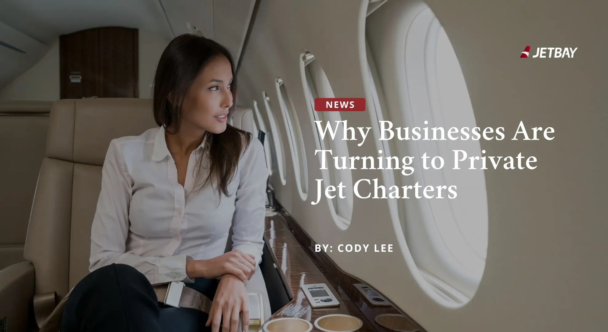Professional businesswoman reading documents aboard luxury private jet cabin with JETBAY branding