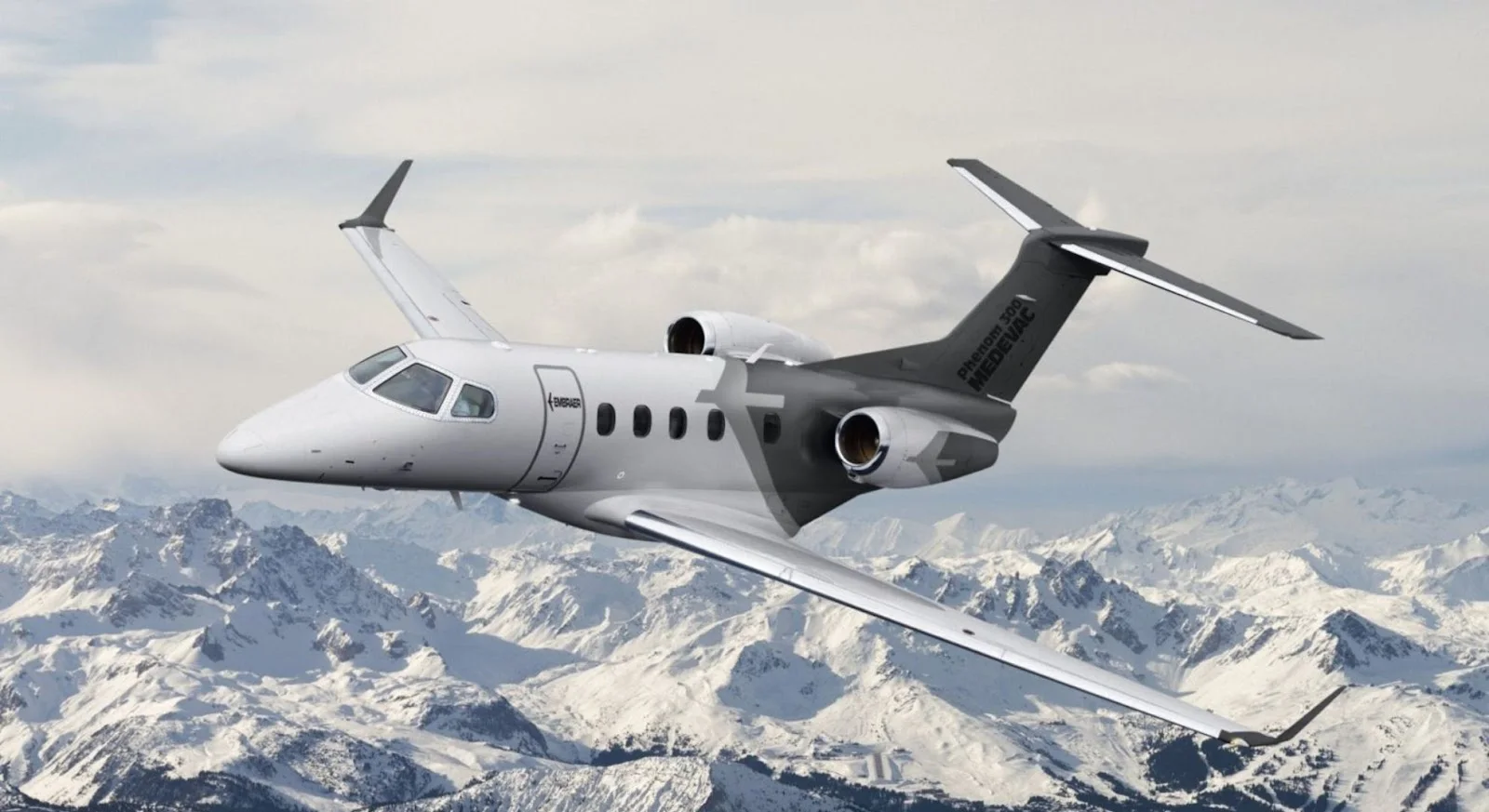 White private jet soaring above snow-capped mountains showcasing luxury empty leg charter opportunities