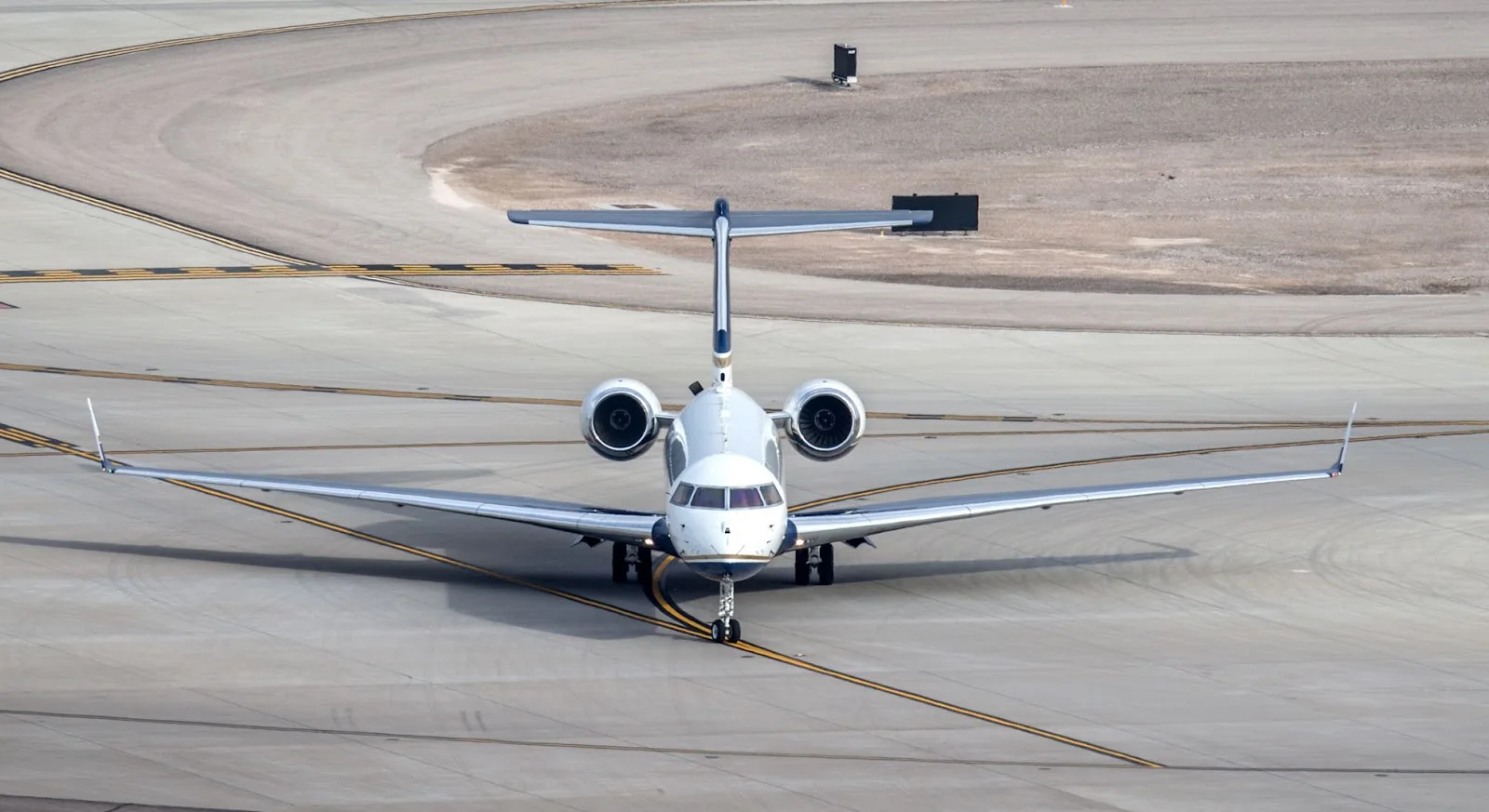 White private jet positioned on airport tarmac ready for empty leg charter flight departure