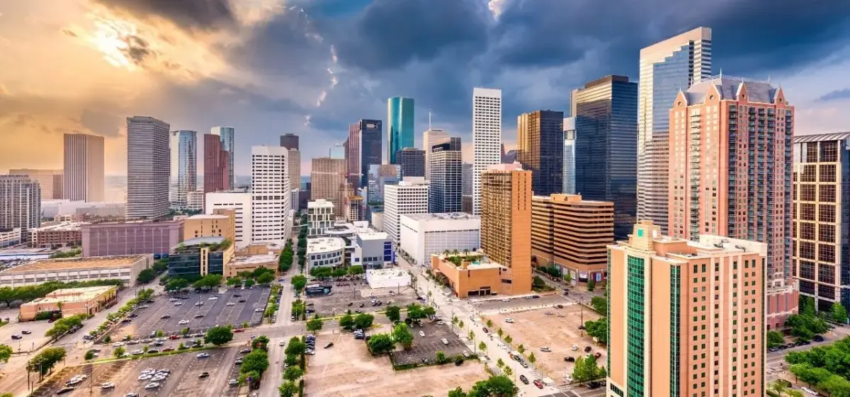 Aerial panoramic view of downtown Houston skyline at golden hour, a premier private jet charter destination in Texas