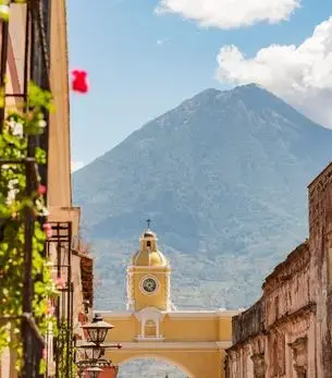 Colonial street in Antigua Guatemala with volcano landscape in the background