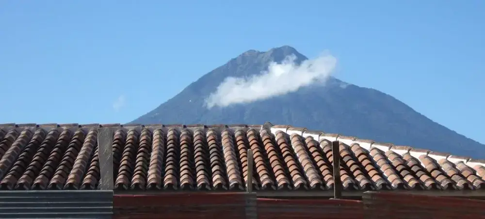 Rooftop view across Antigua Guatemala with volcanoes in the distance