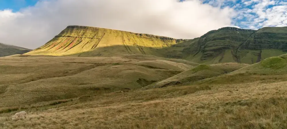 Sweeping green hillsides and flat-topped peak of Bannau Brycheiniog (Brecon Beacons), a premier Wales private jet destination