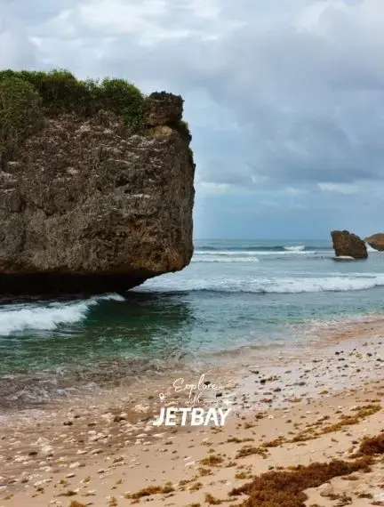 Dramatic Bathsheba Beach coastline in Barbados with iconic mushroom rock formation, turquoise waves, and sandy shore