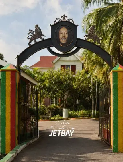 Ornate entrance gate to the Bob Marley Museum in Kingston, Jamaica, featuring iconic Rasta colours and a lion crest
