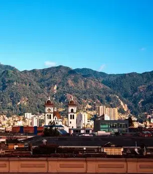 Aerial view of Bogotá Colombia with the Andes mountains behind the city skyline