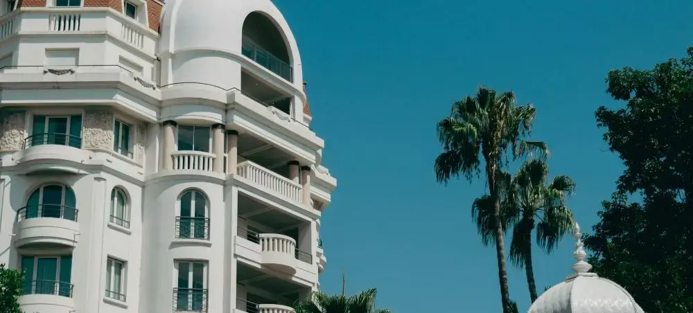 Boulevard de la Croisette in Cannes with hotels, palms, and Mediterranean seafront