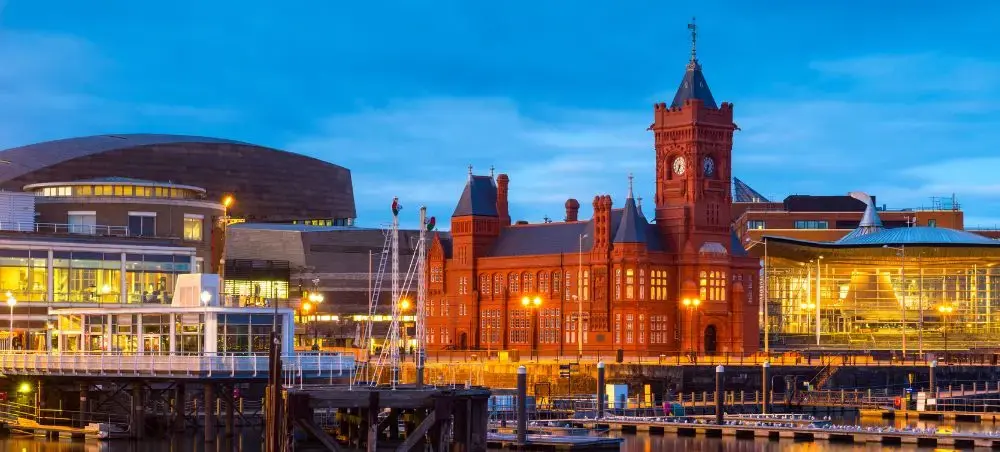 Cardiff Bay waterfront at dusk featuring the iconic Pierhead Building and Wales Millennium Centre