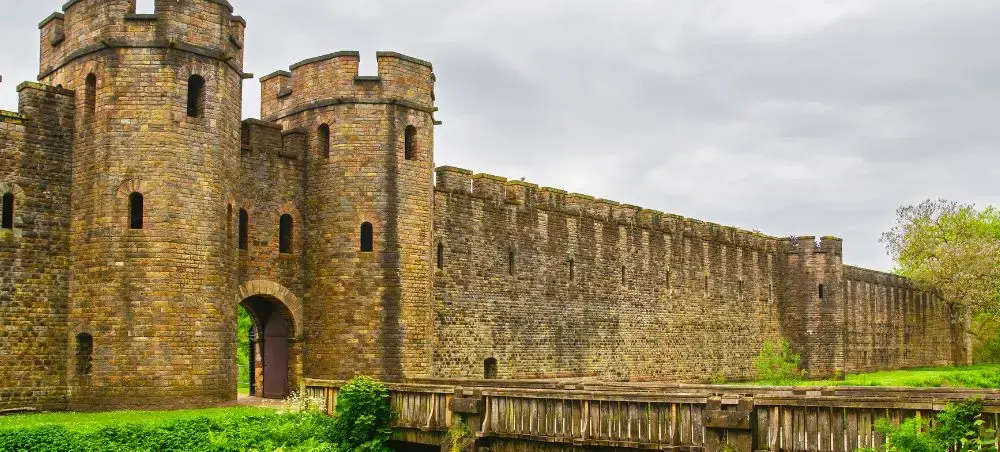 Cardiff Castle's medieval stone gatehouse and battlemented walls with wooden drawbridge