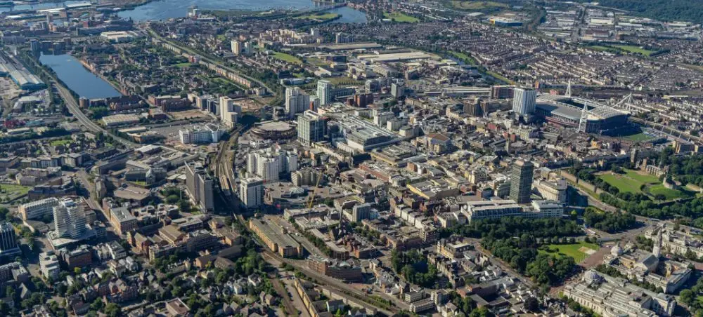 Aerial view of Cardiff city centre showing Cardiff Castle, Principality Stadium, Cardiff Bay waterfront and the Welsh skyline