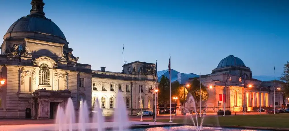 Cardiff City Hall and National Museum illuminated at dusk, landmarks for private jet travellers visiting Cardiff, Wales