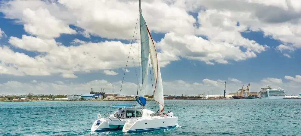 Catamaran yacht sailing off the coast of Barbados on cloudy day
