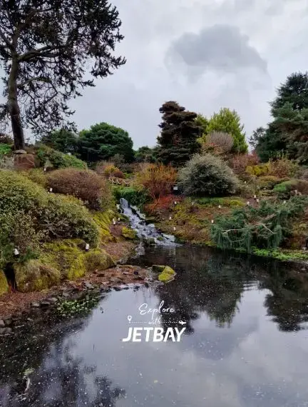 Seasonal planting and lawns at Royal Botanic Garden Edinburgh with the city beyond
