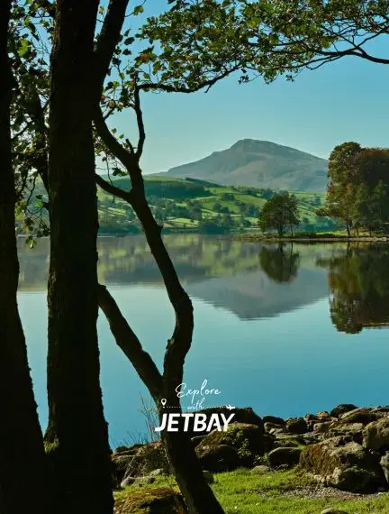Llyn Tegid lake in southern Eryri, Wales, surrounded by hills and open countryside