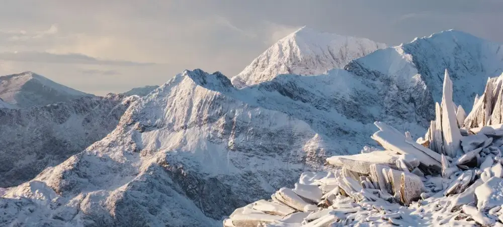 Snow-covered peaks of Eryri (Snowdonia) National Park in winter, a destination for private jet travellers flying to Wales