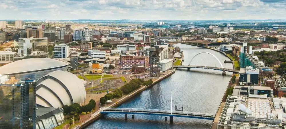 Aerial view of Glasgow city centre with the River Clyde, Clyde Arc bridge, and SEC Armadillo venue, accessible by private jet