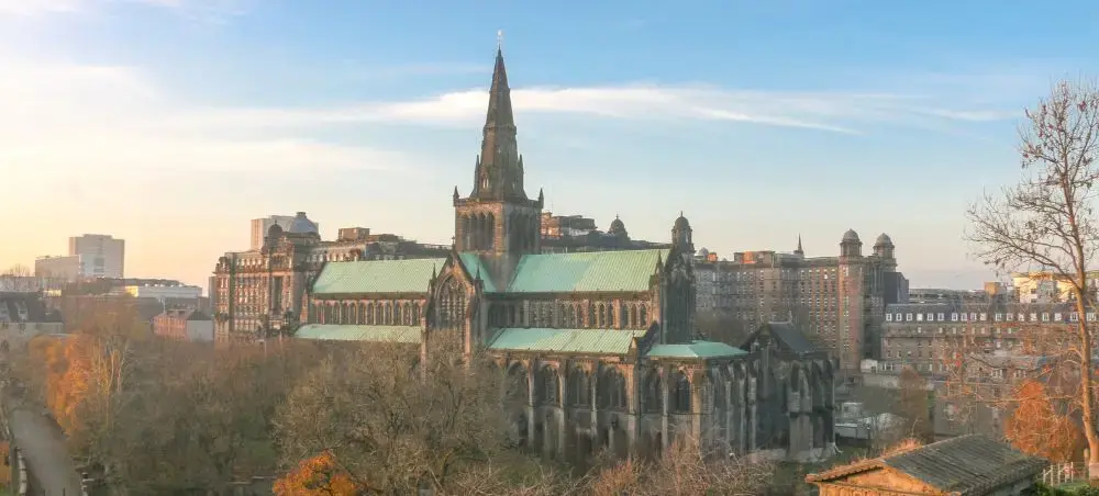 Aerial panoramic view of Glasgow Cathedral and city skyline at golden hour, a destination accessible by private jet charter