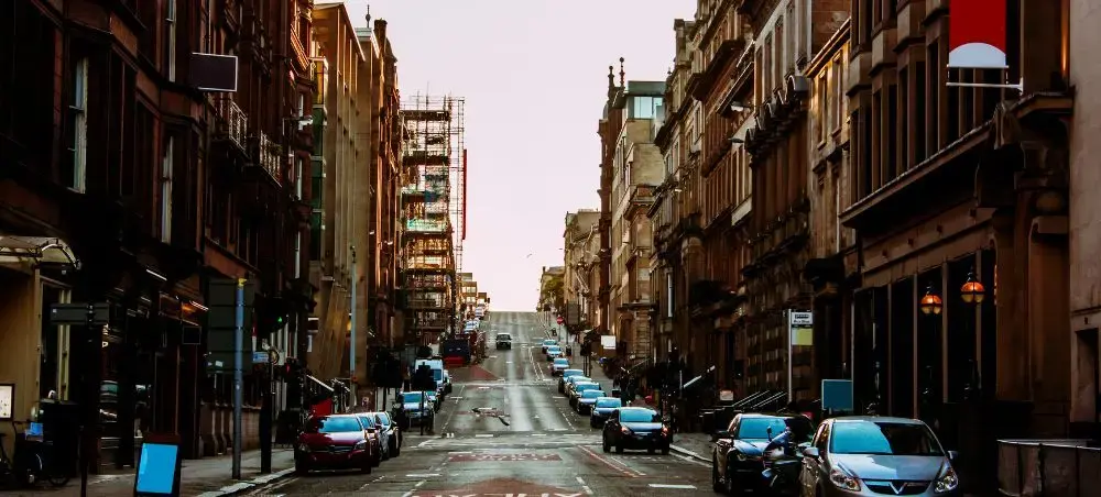 Historic Glasgow city centre street lined with sandstone buildings, representing the urban gateway for private jet charter