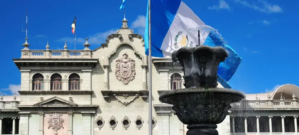 Ciudad de Guatemala in Guatemala City with a large Guatemalan flag and the National Palace's monumental facade