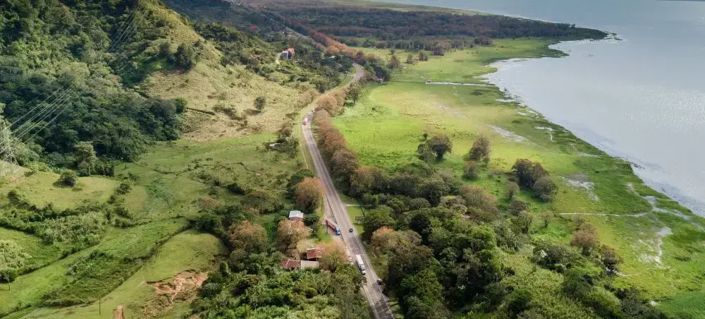 Aerial view of Honduras showing Caribbean coastline, roads, and green mountains