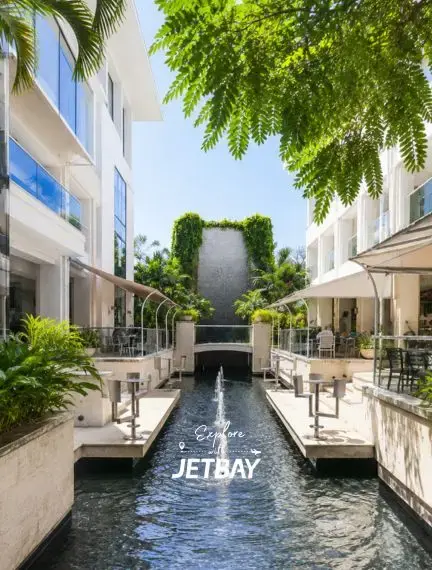 Limegrove Lifestyle Centre's elegant open-air courtyard with water feature and lush greenery in Holetown, Barbados