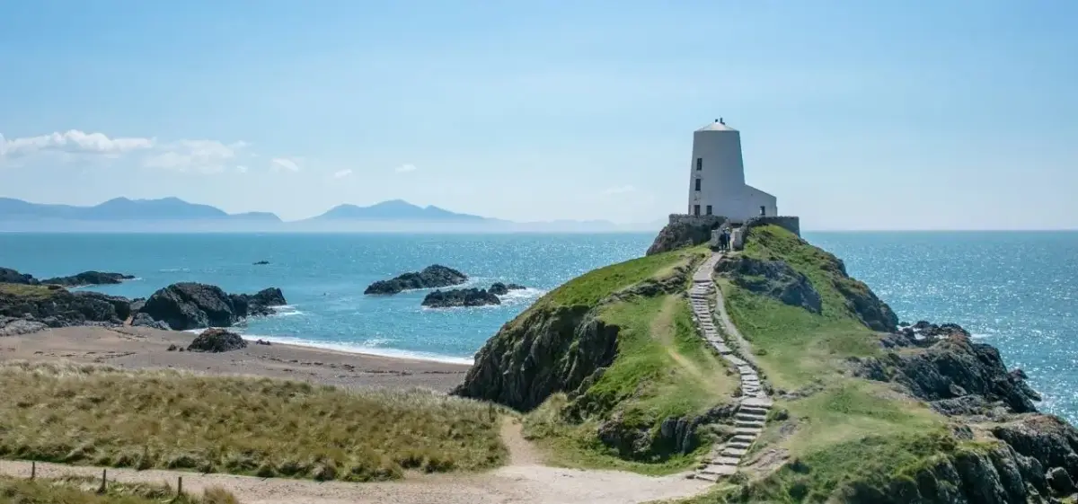 Tŵr Mawr lighthouse on Llanddwyn Island, Anglesey, a scenic coastal landmark accessible when flying private to Wales
