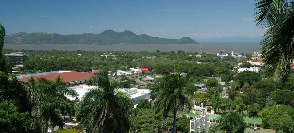 Modern city district in Managua, Nicaragua with tropical trees and urban buildings