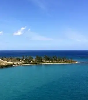 Aerial view of Montego Bay coastline with turquoise Caribbean waters, sandy shore, and resort buildings
