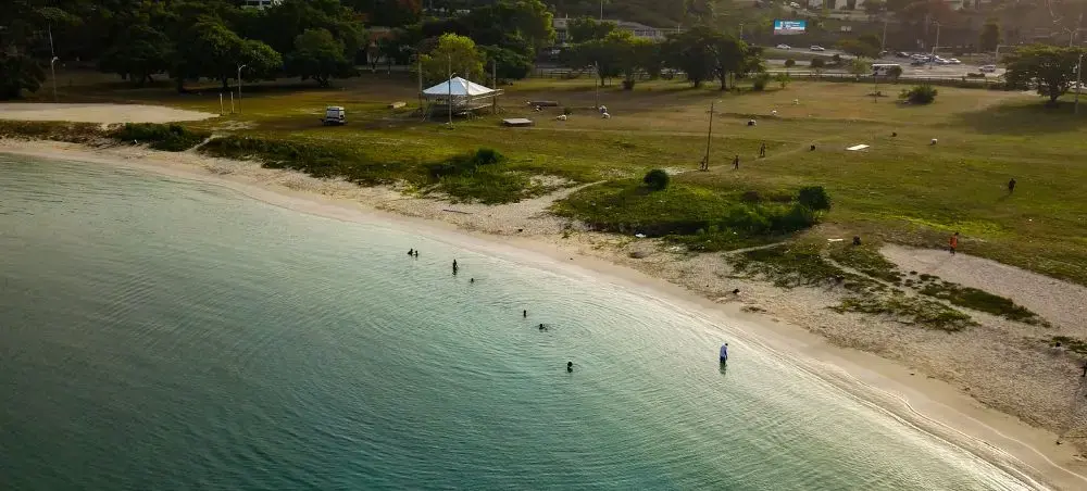 Aerial view of Montego Bay Jamaica shoreline with turquoise Caribbean waters, white sand beach, and lush green parkland
