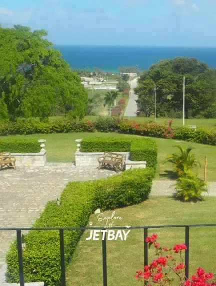 Lush tropical gardens with manicured hedges and ocean views at a Montego Bay luxury estate near Rose Hall Great House