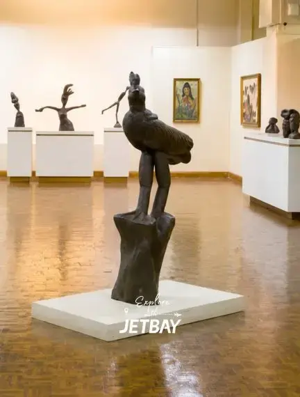 Interior of the National Gallery of Jamaica in Kingston featuring bronze sculptures and paintings in a sunlit gallery hall