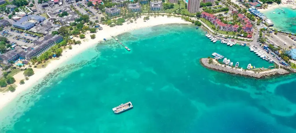 Aerial view of Ocho Rios, Jamaica with coastline, resorts, and tropical hills