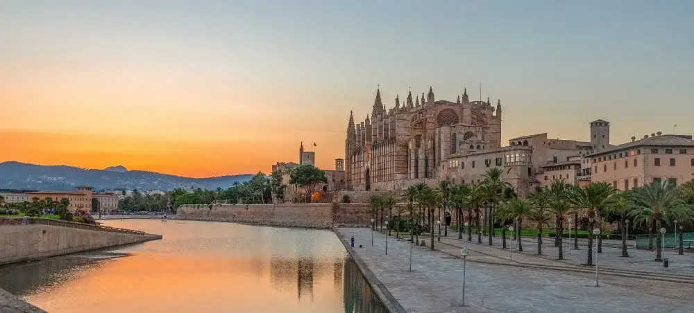 Palma Cathedral and waterfront in Palma, Spain, overlooking the Bay of Palma at golden hour