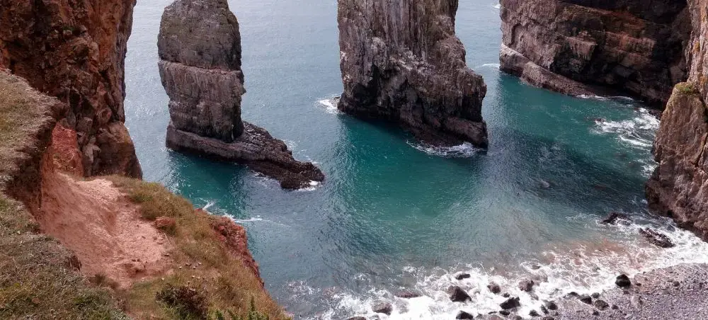 Sea stacks rising from waters along the Pembrokeshire coastline, a natural landmark accessible by private jet to West Wales