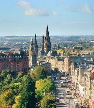 Aerial view of Edinburgh city centre featuring Gothic cathedral spires and Princes Street, accessible by private jet charter