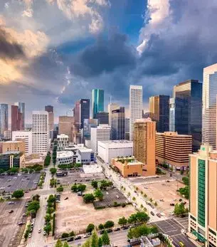 Aerial panoramic view of downtown Houston skyline at golden hour, a premier private jet charter destination in Texas
