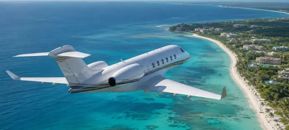 Private jet flying above Punta Cana and the Caribbean coastline