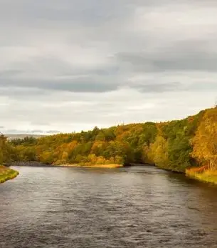 Autumn colours along the River Spey in Speyside, Scotland, a premier private jet charter destination for whisky distillery