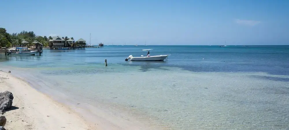 Boat on clear reef water off Roatán, Honduras