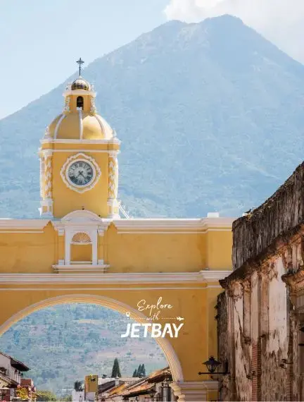 Santa Catalina Arch in Antigua Guatemala with volcano view in the background