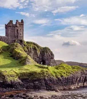 Scottish castle on rugged coastal cliffs overlooking the Scottish Highlands, a destination accessible by private jet charter