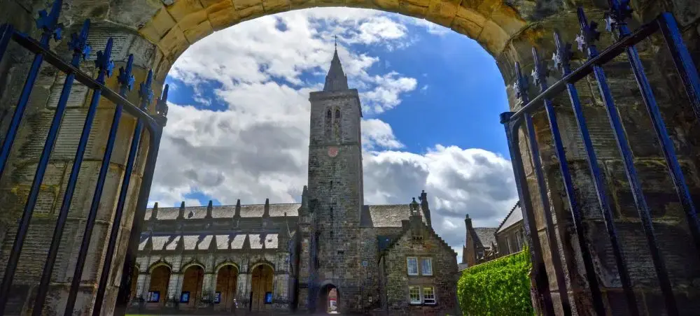 University of St Andrews viewed through ornate iron gates, a destination for private jet charter visitors to Scotland