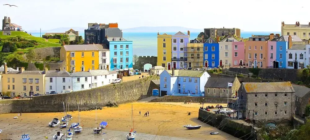 Colourful Georgian townhouses overlooking Tenby Harbour, a destination accessible by private jet to Pembrokeshire, Wales