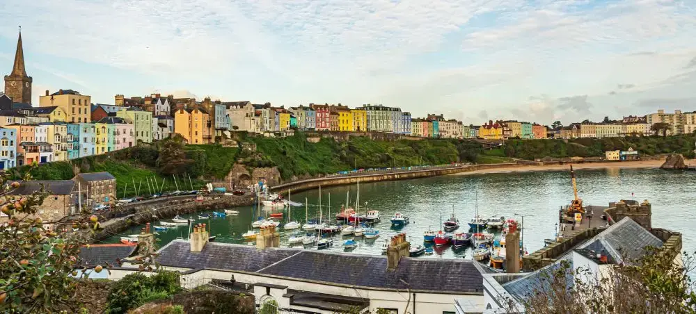 Colourful waterfront buildings overlooking Tenby harbour in Pembrokeshire, Wales, accessible by private jet charter