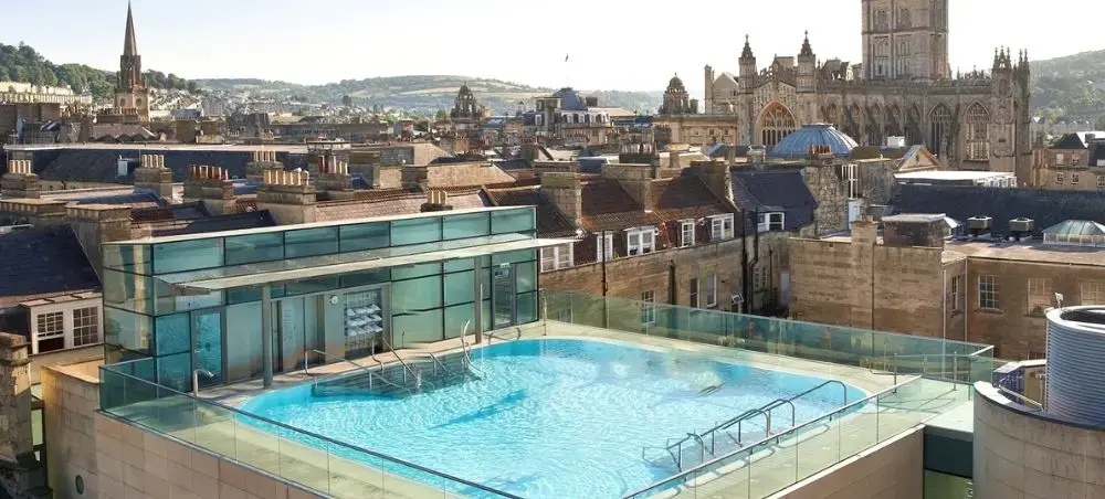 Rooftop thermal pool at Thermae Bath Spa overlooking Bath Abbey and the Georgian rooftops of Bath, England