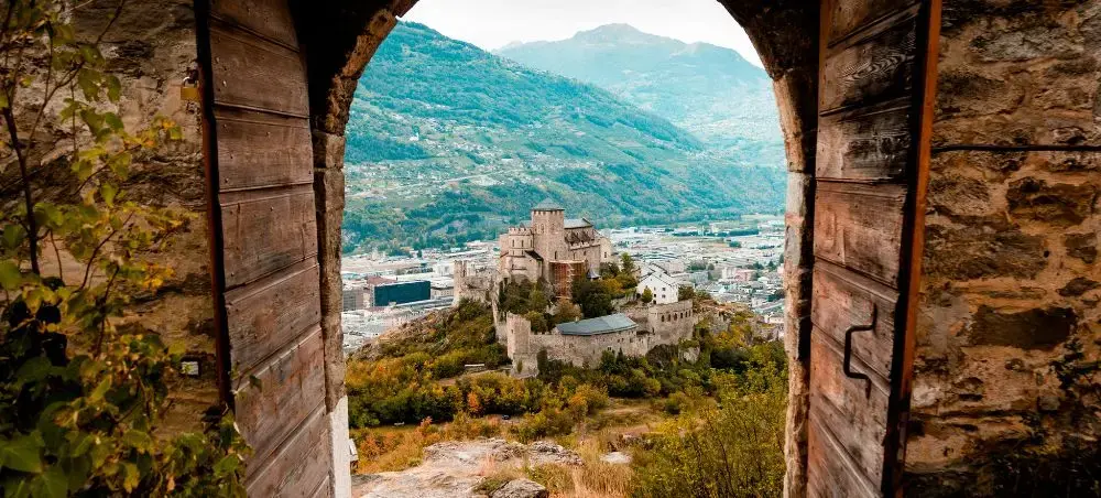 Medieval Valere basilica seen through the main gates of Tourbillon Castle located in canton Valais, Sion, Europe