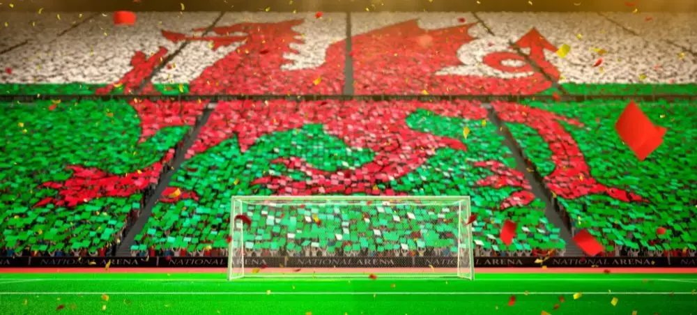 Welsh dragon flag recreated by fans in stadium stands at Wales National Arena, celebrating a major football match