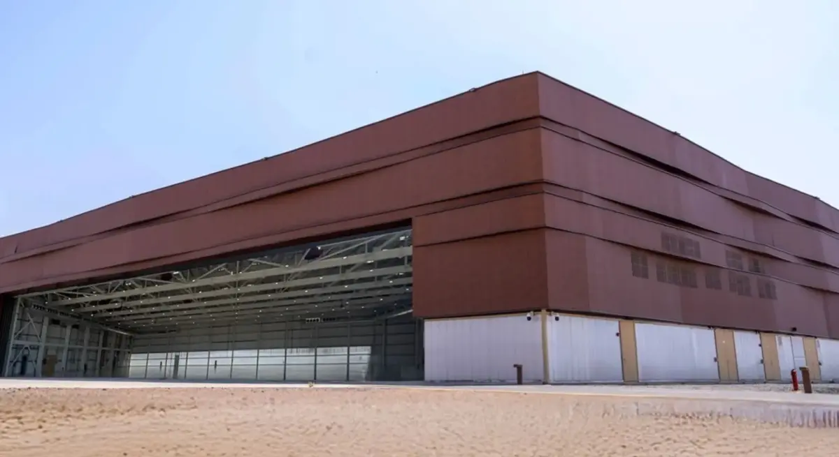 Expansive modern private aviation hangar at AlUla Airport FBO, featuring open bay doors and premium facilities for private jet charter in Saudi Arabia